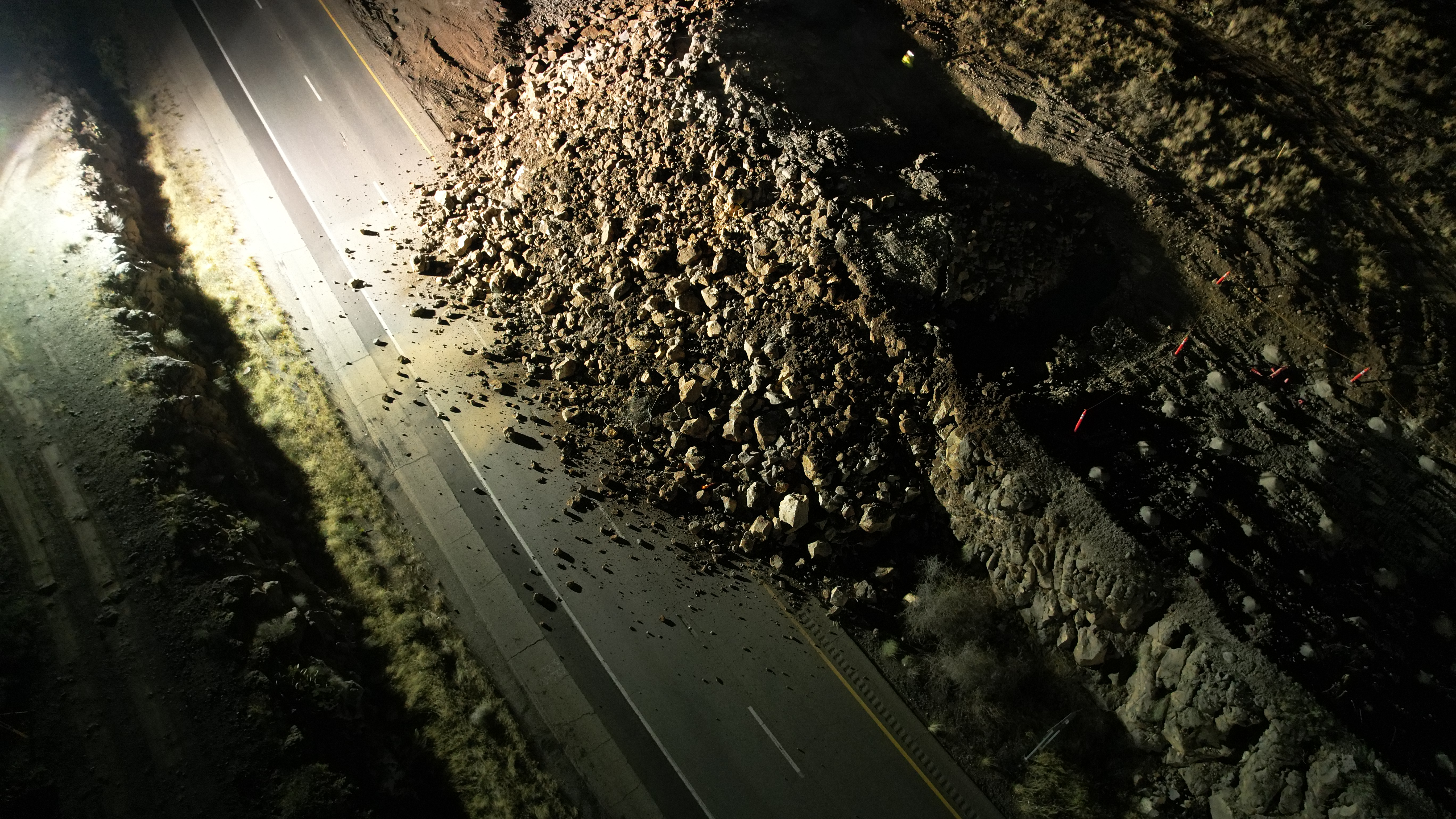 Rock covers a highway after rock blasting.