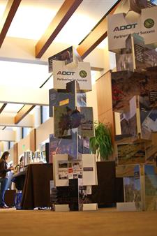 Display of photos stacked vertically, and offset ninety degrees, showcasing ADOT's recent efforts.