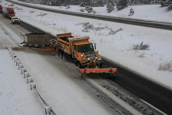 Tow snow plow clears snow along I-40.