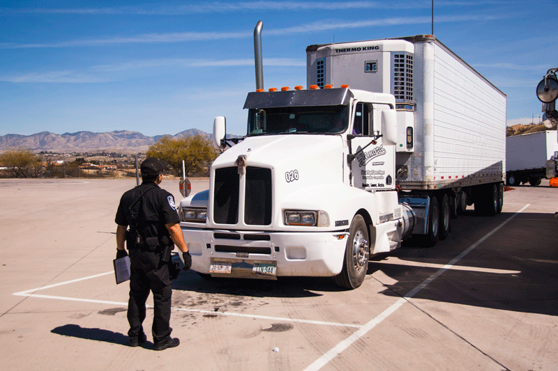 Port of Entry Officer in front of semi
