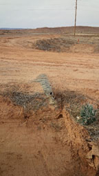 Aerial view of uncovered drainage pipe section 