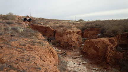 Dual drainage pipes over a ravine