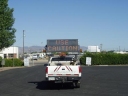 Alert-vehicle-small Vehicel with alert sign on back in parking lot