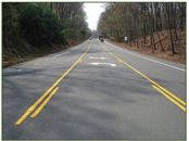 Three Lanes without Raised Median (one lane each way with two-way left-turn lane); photo by FHWA