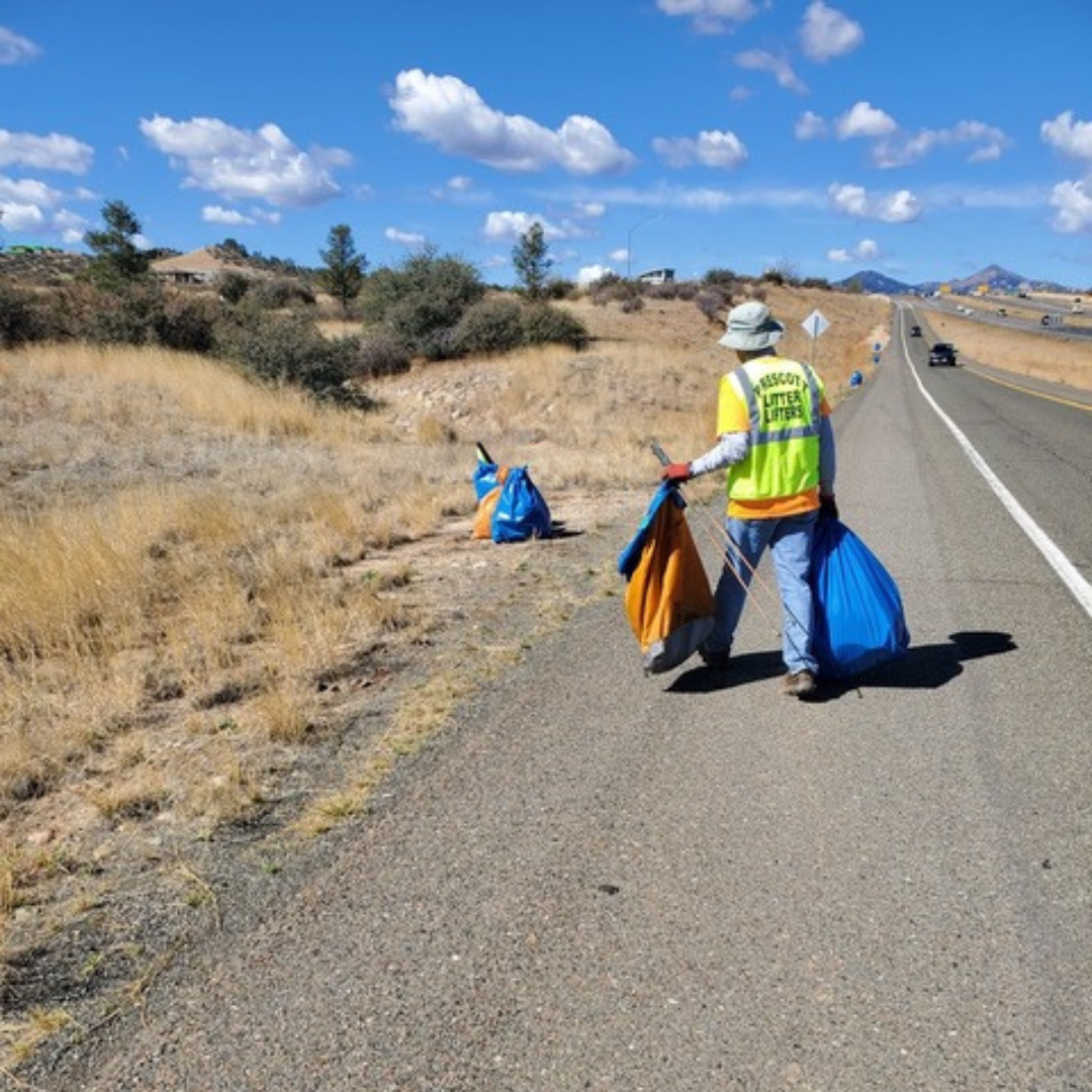 An Adopt a Highway volunteer collects litter