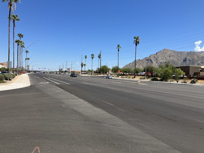 State Route 77 with new pavement lined by palm trees.
