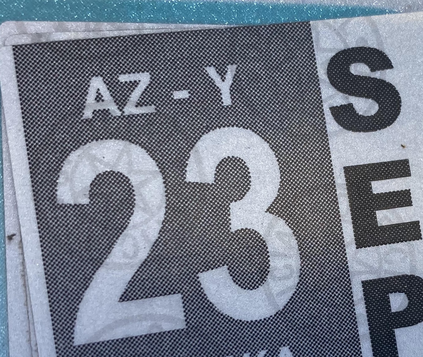 A vehicle registration sticker on a license plate.