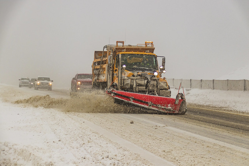 A snowplow removing snow from travel lanes in Northern Arizona