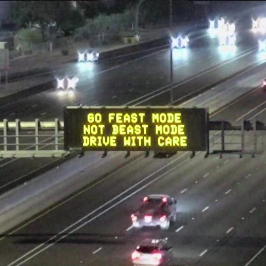 A digital message board on the highway encourages motorists to drive safely.