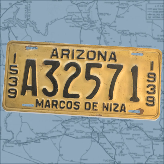 A yellow license plate with black lettering and numbers atop a map of Arizona.