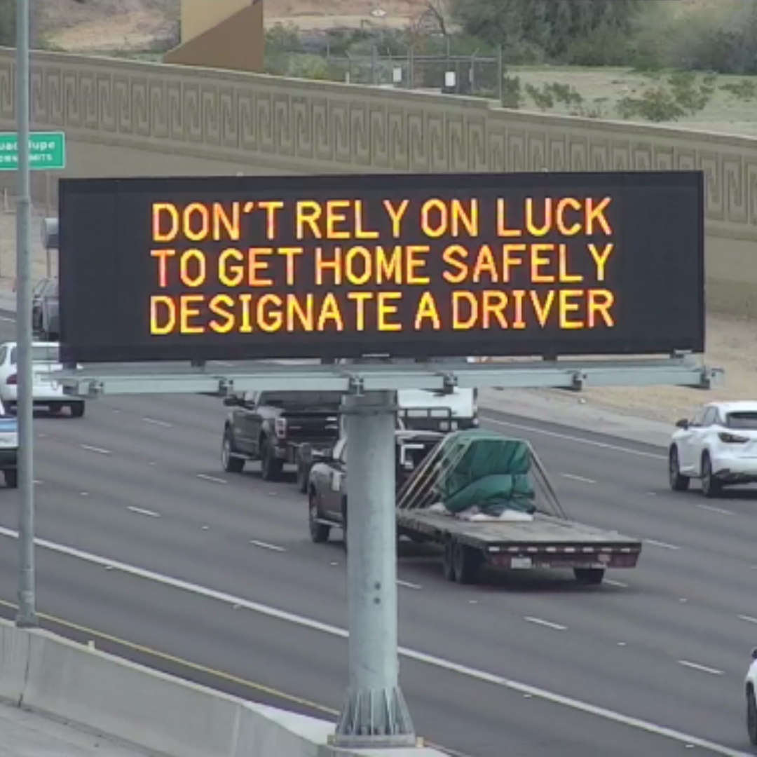 A digital message board on the highway encourages motorists to designate a driver.