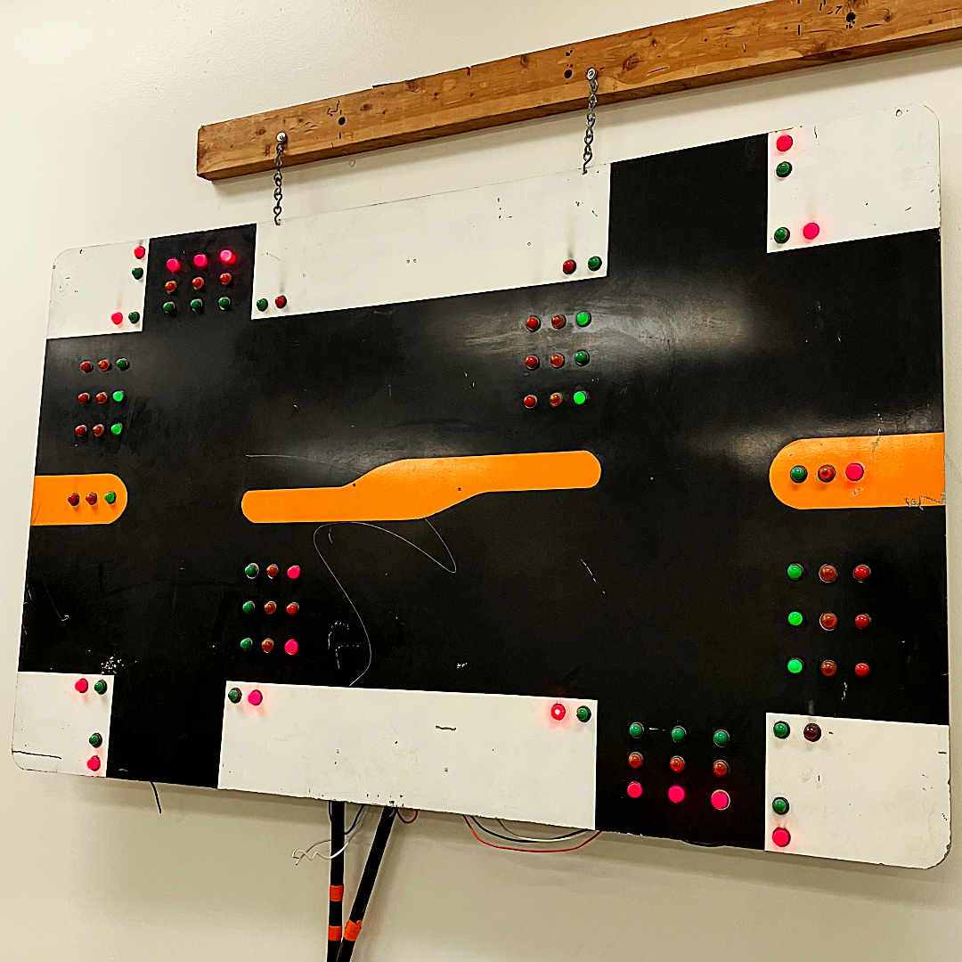 A signal devide used for timing traffic signals and other training purposes hangs on a wall.