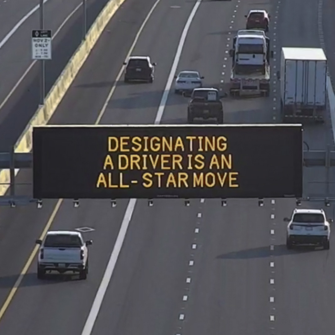 A digital message board on the highway encourages motorists to designate a driver.