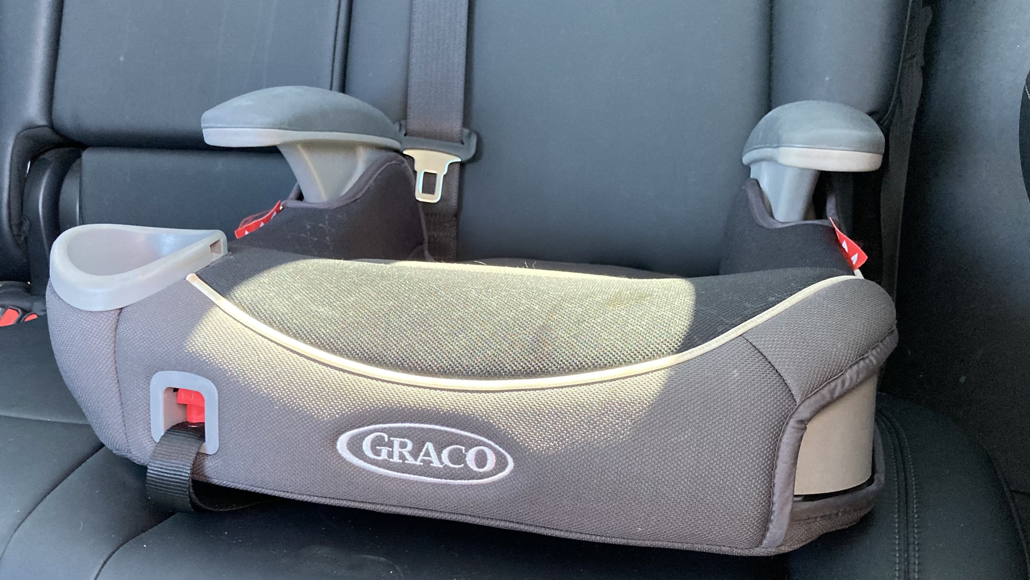 A booster seat inside a car. 