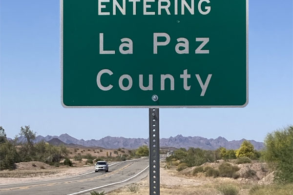 car on highway sign entering La Paz County