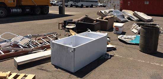 pile of debris including refrigerator