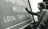 Man painting road sign in the shop