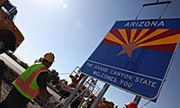 Putting up a Welcome to Arizona sign