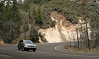 Car going around curve in mountainy area