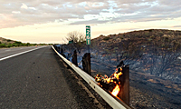 Wooden guardrail support on fire