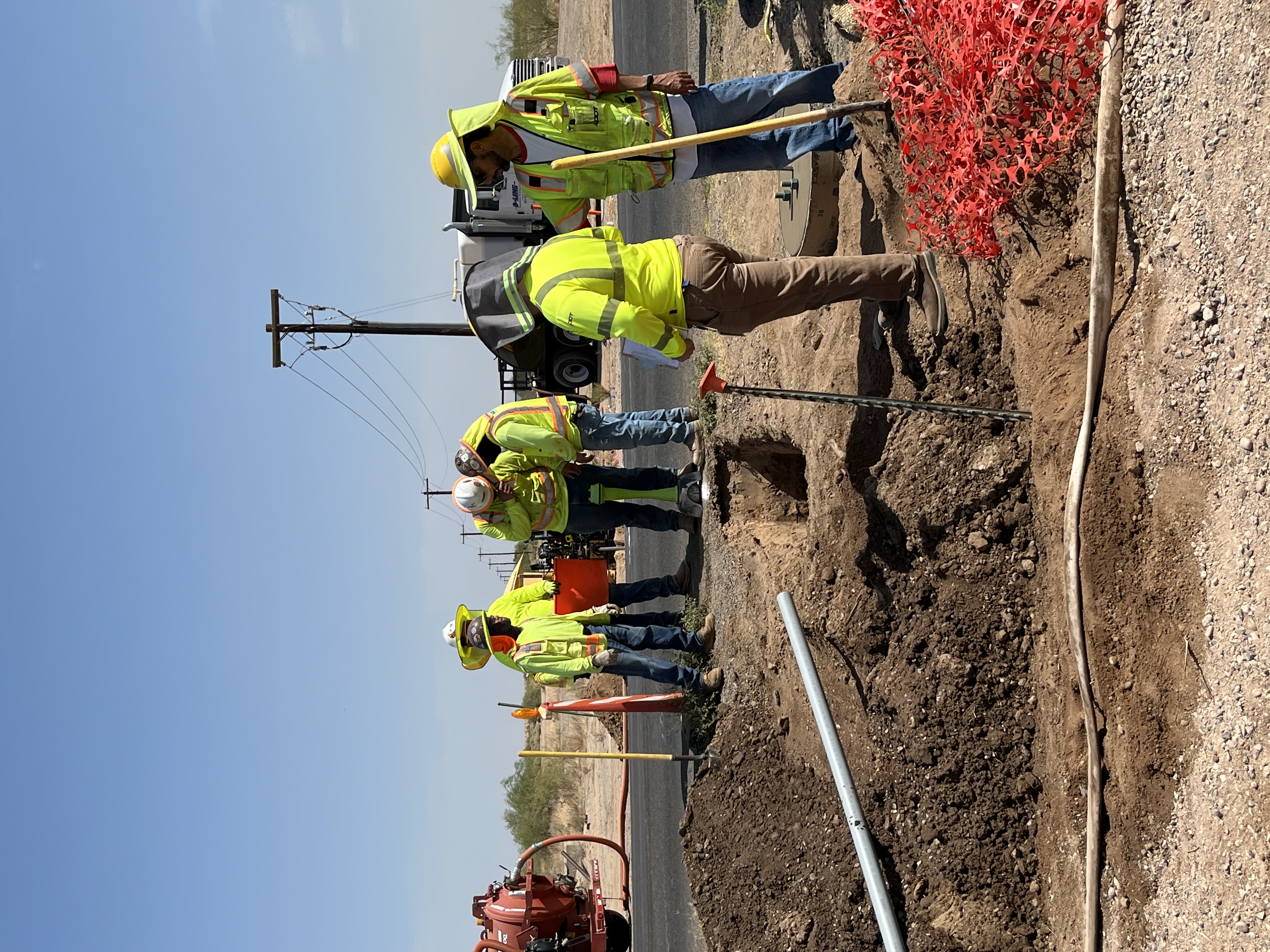 Construction workers moving a pipe in Eloy view 2