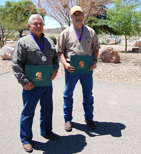 Frank Gidney and Lonnie Baca, right, accepting awards