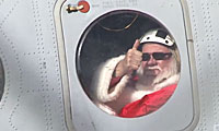 Santa giving thumbs up through helicopter window