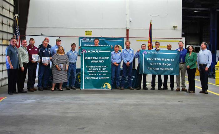 Group of ADOT workers holding banners for green shop award.