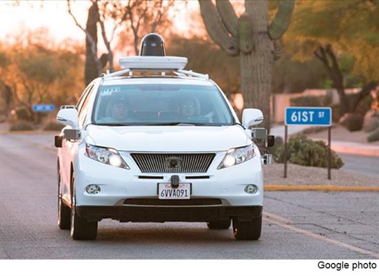 White Self-driving sedan front view on road