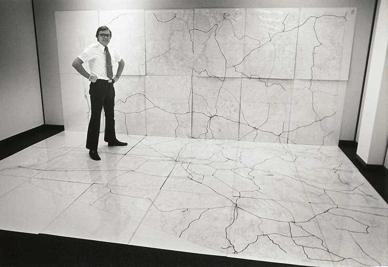 Man standing on large map on the floor and up the wall