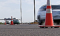 Traffic cones and cars on road