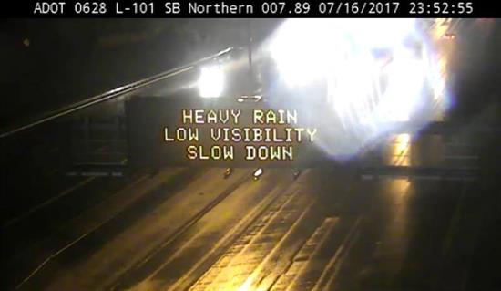Image of DMS that reads "Heavy rain, Low visibility, Slow down" 