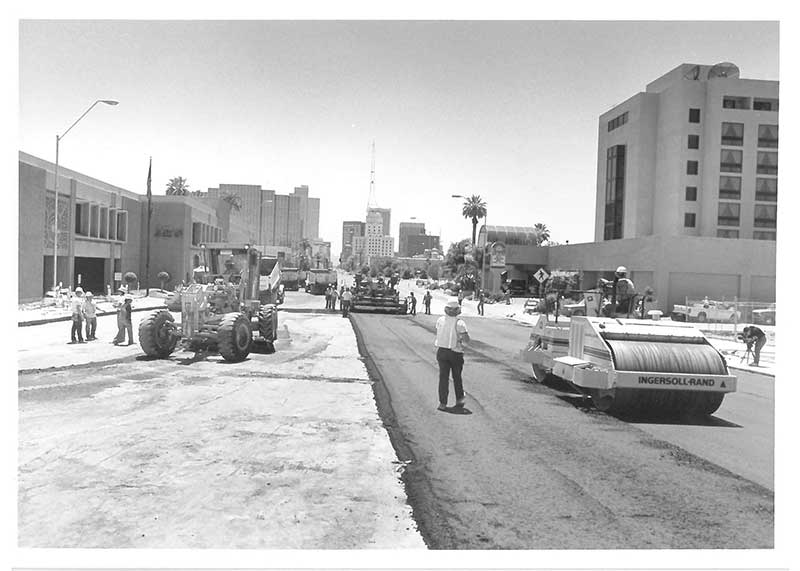 Black and white photo of road paving machines working on Central Avenue