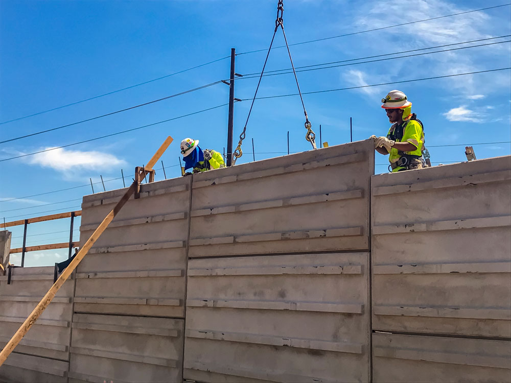 Workers build freeway soundwall amid extreme heat