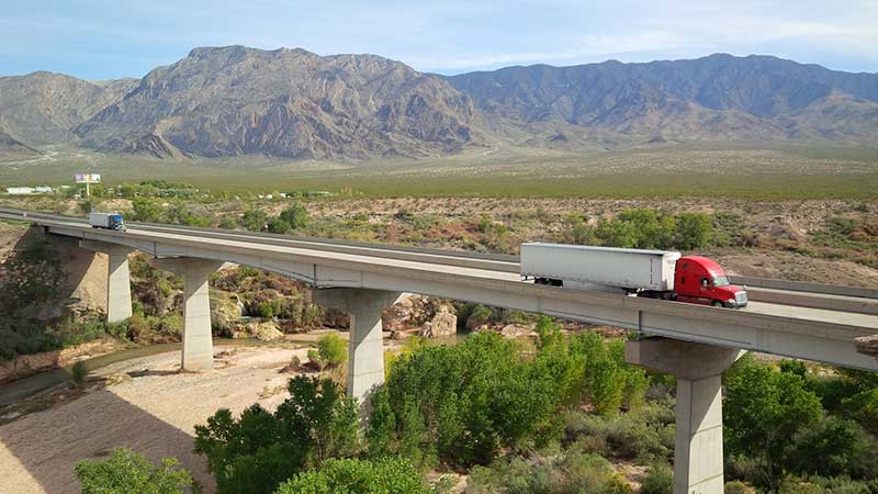Image of semi truck driving over I-15 bridge