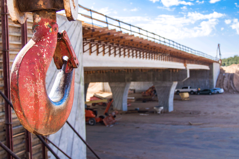 Close up of hook on machinery by bridge