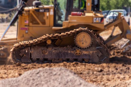 Earth mover vehicle in focus with dirt blurry