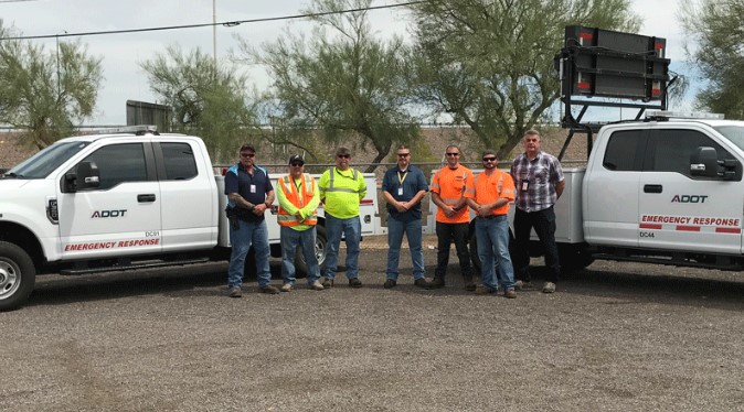 Incident Response Unit members pose with two trucks