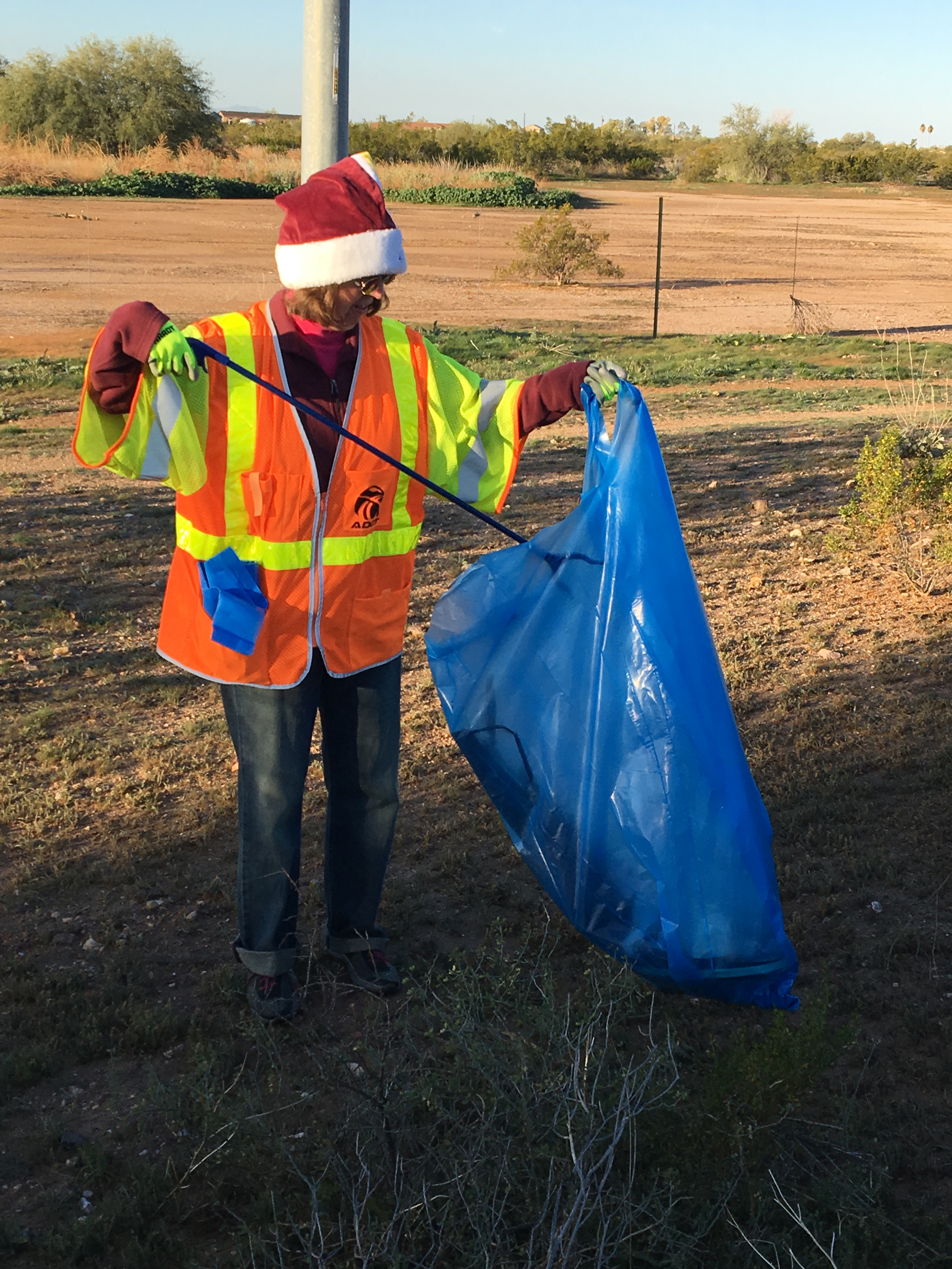 Adopt a Highway volunteer wearing Santa hat
