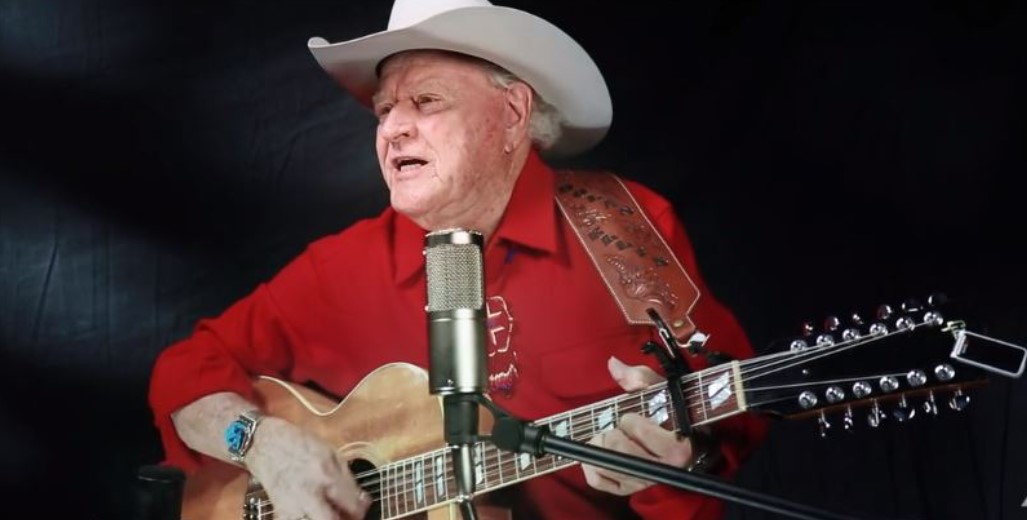 State balladeer Dolan Ellis plays guitar and sings