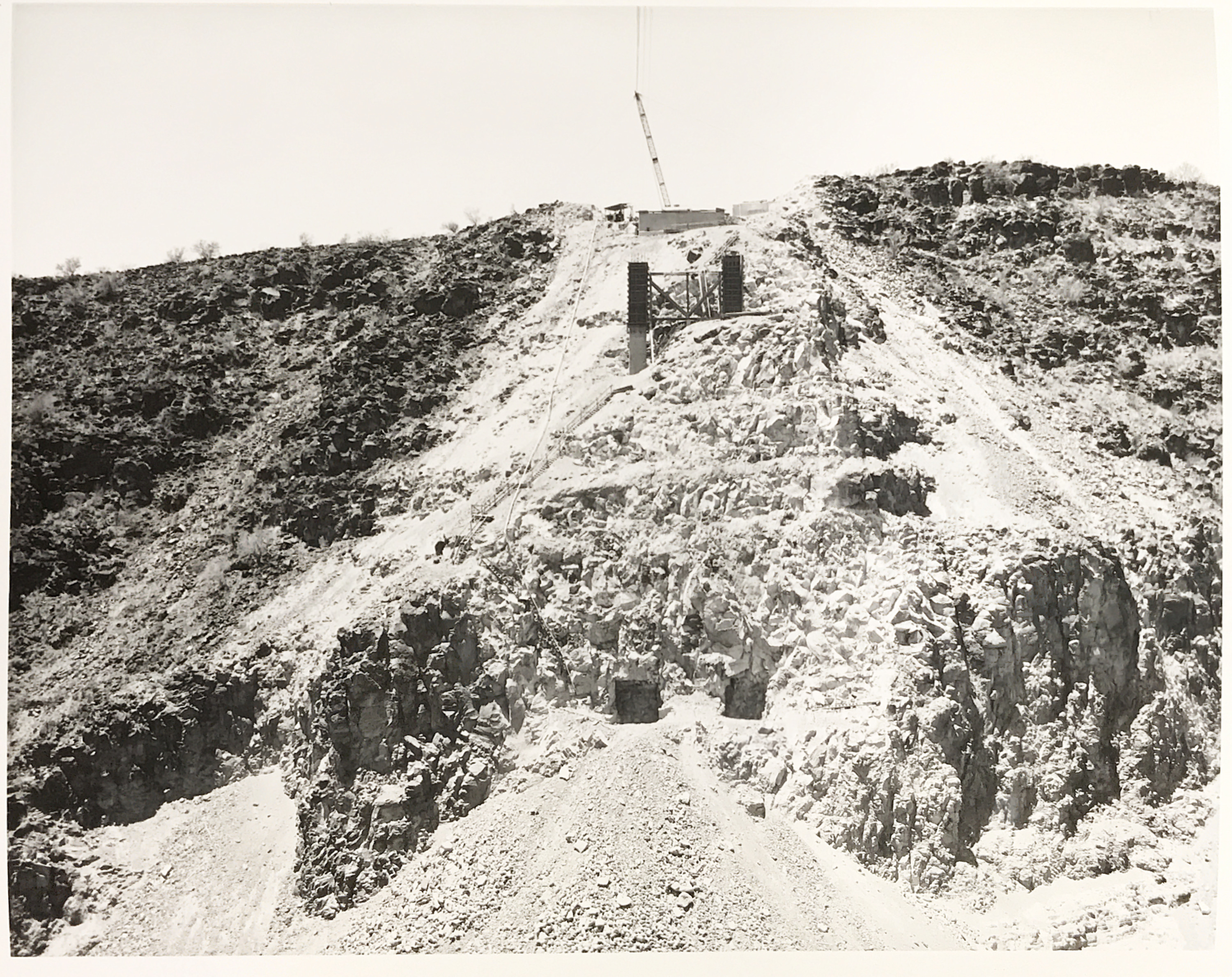 Black and white image of construction work done on a steep hill