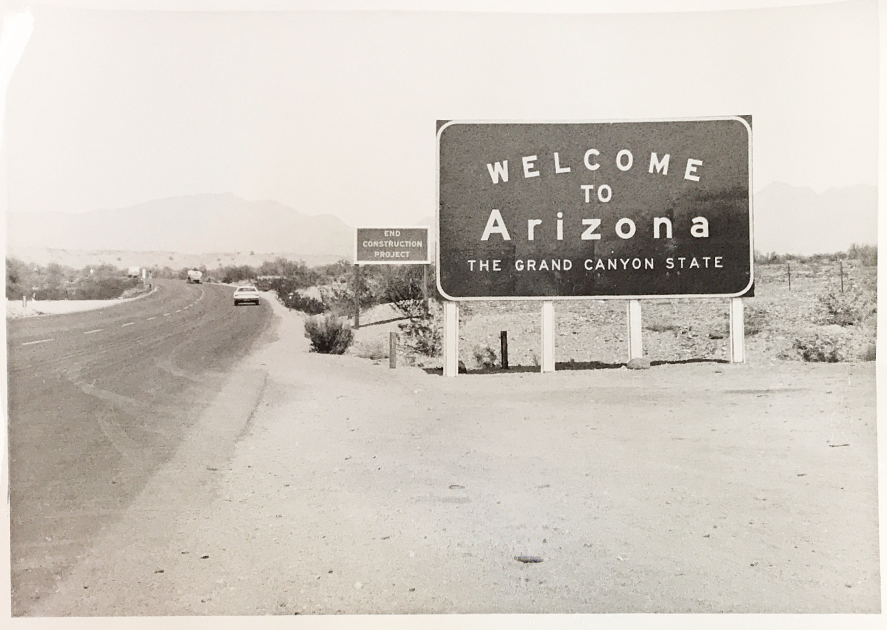 Black and white image of a "Welcome to Arizona" sign
