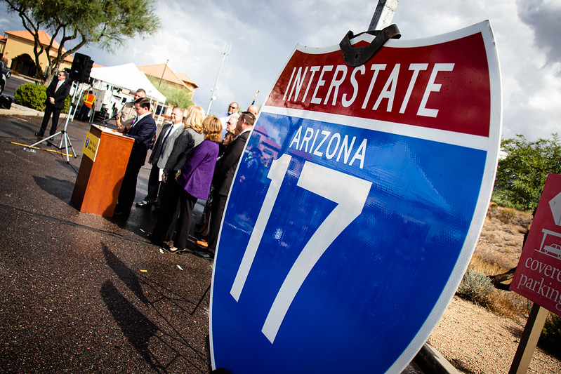 A metal Interstate 17 sign displayed at a news conference