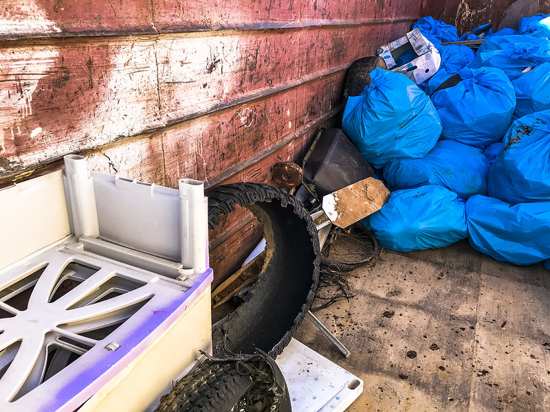 A pile of stocked up road litter in blue bags