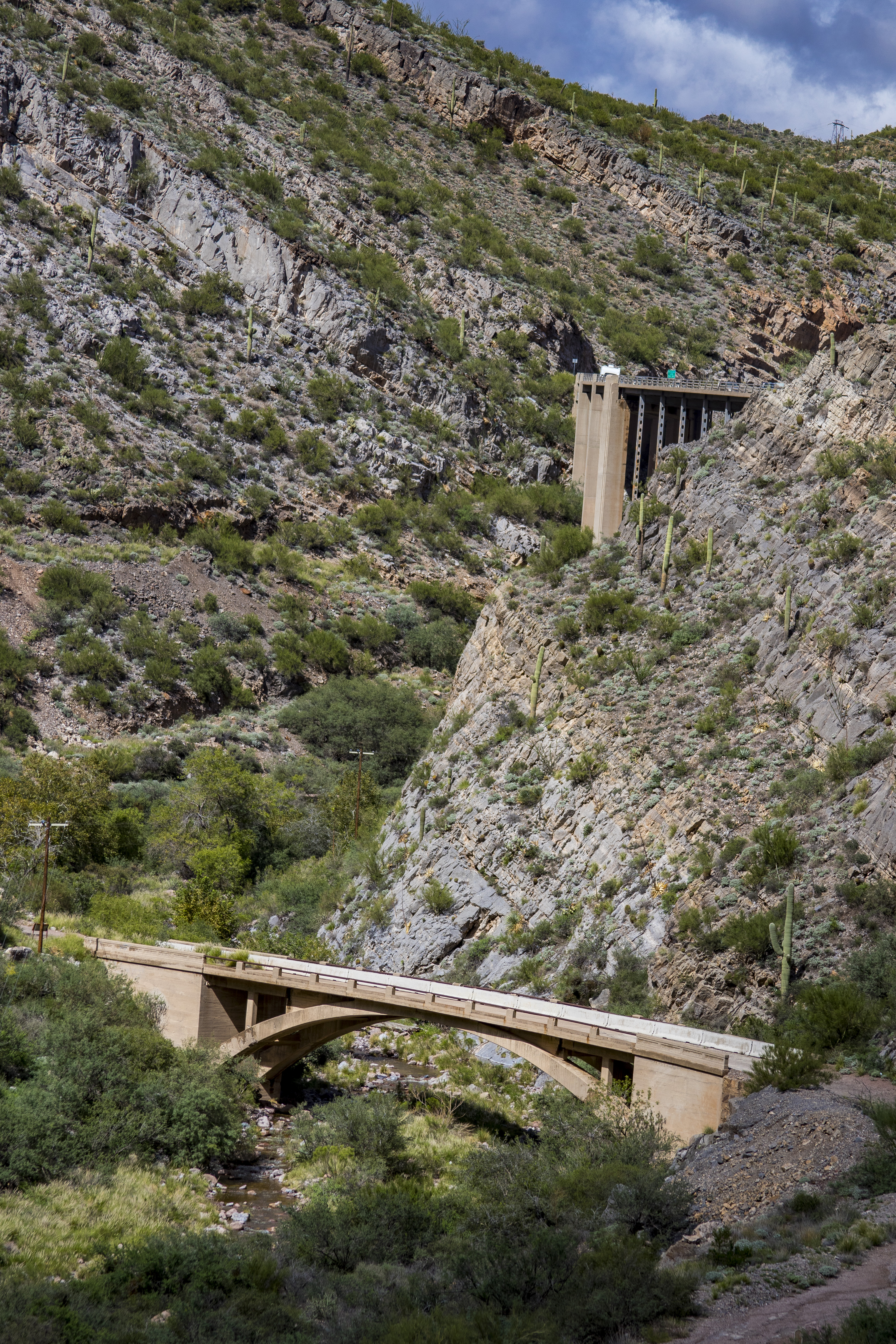 A concrete bridge crosses a rocky canyon