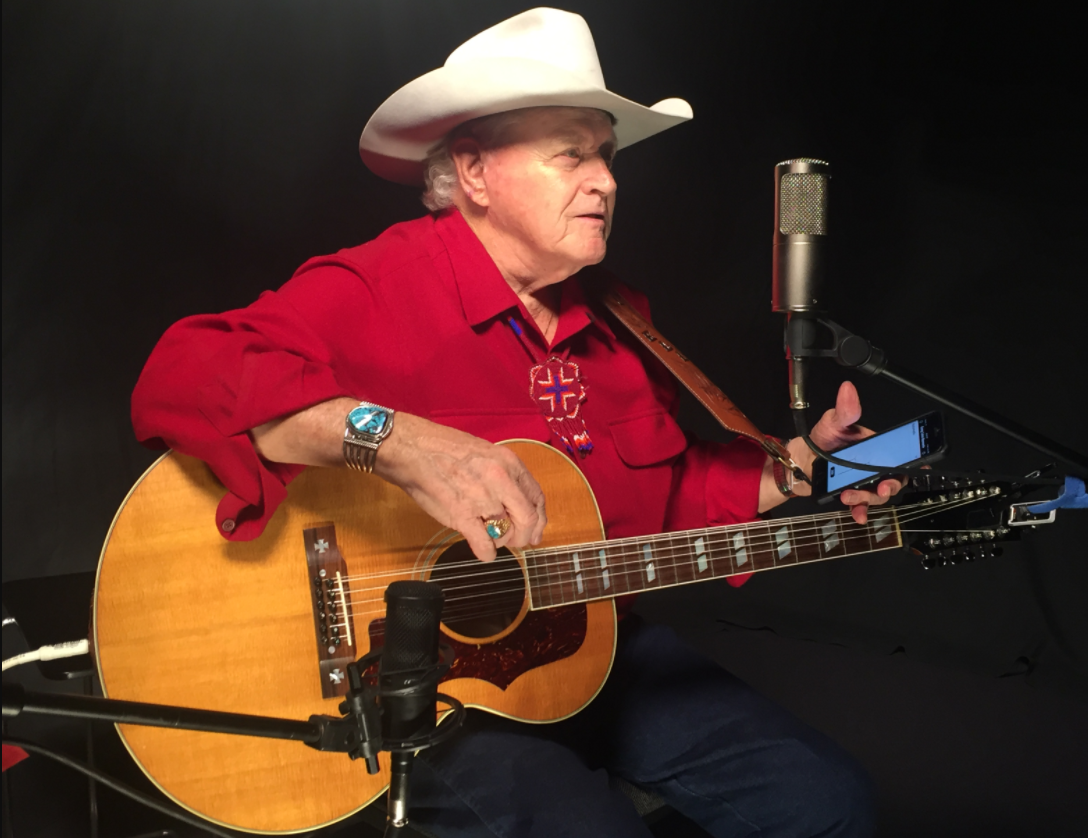 Dolan Ellis suings and strums his guitar.