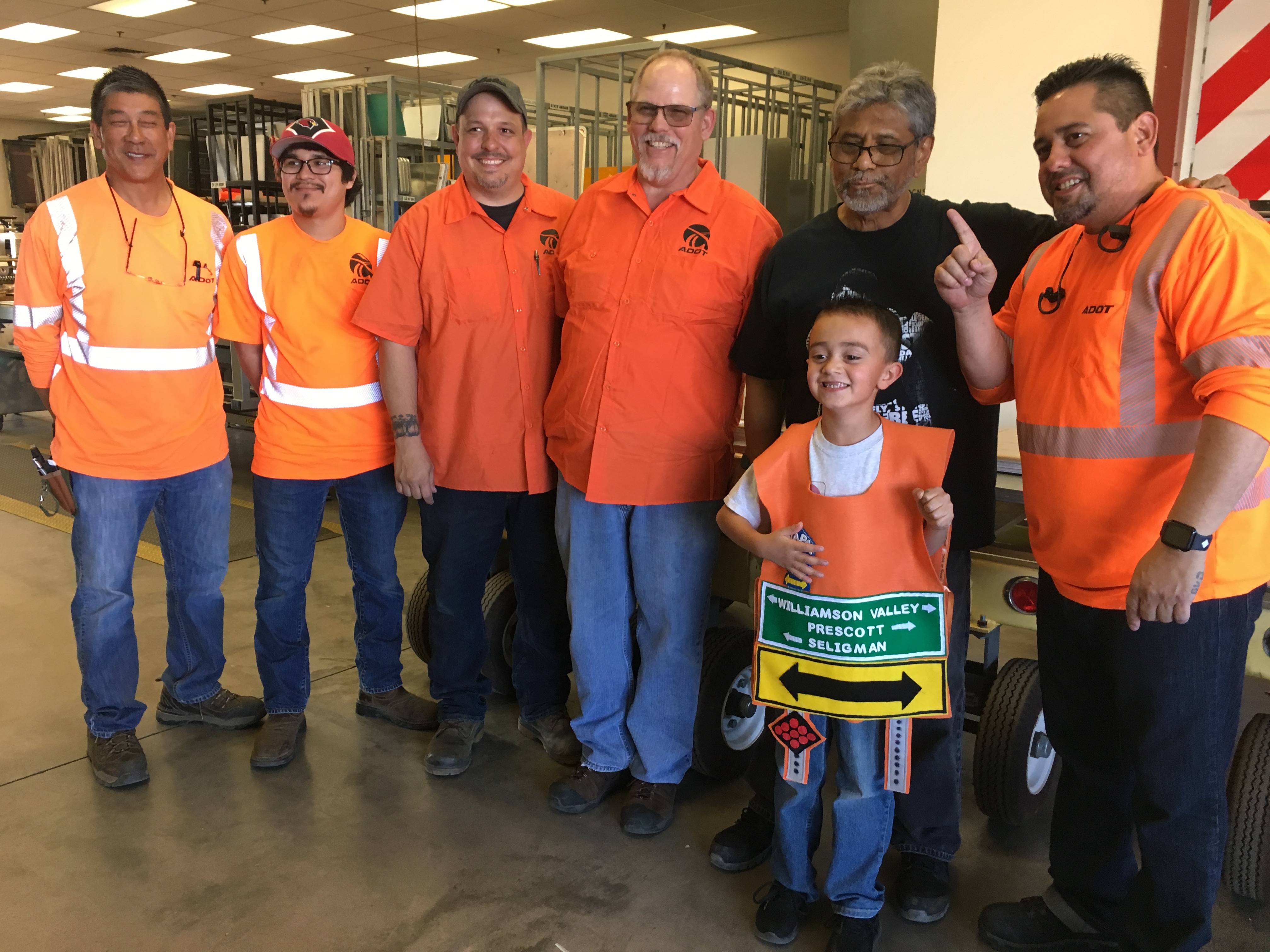 Highway Sign Shop Personnel with a little boy on his tour