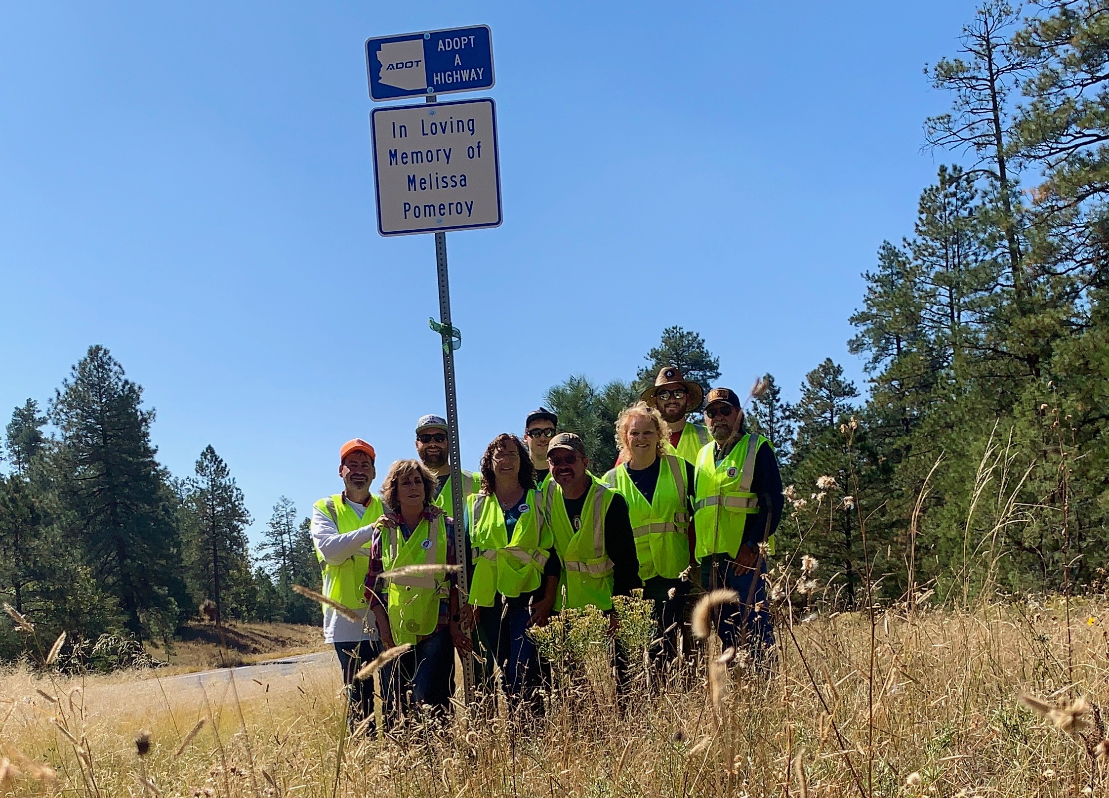 Adopt a Highway sign and group of volunteers