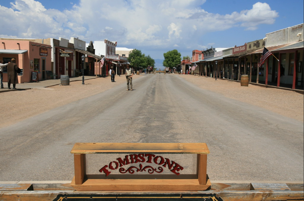 Image of Tombstone sign with the town in the background