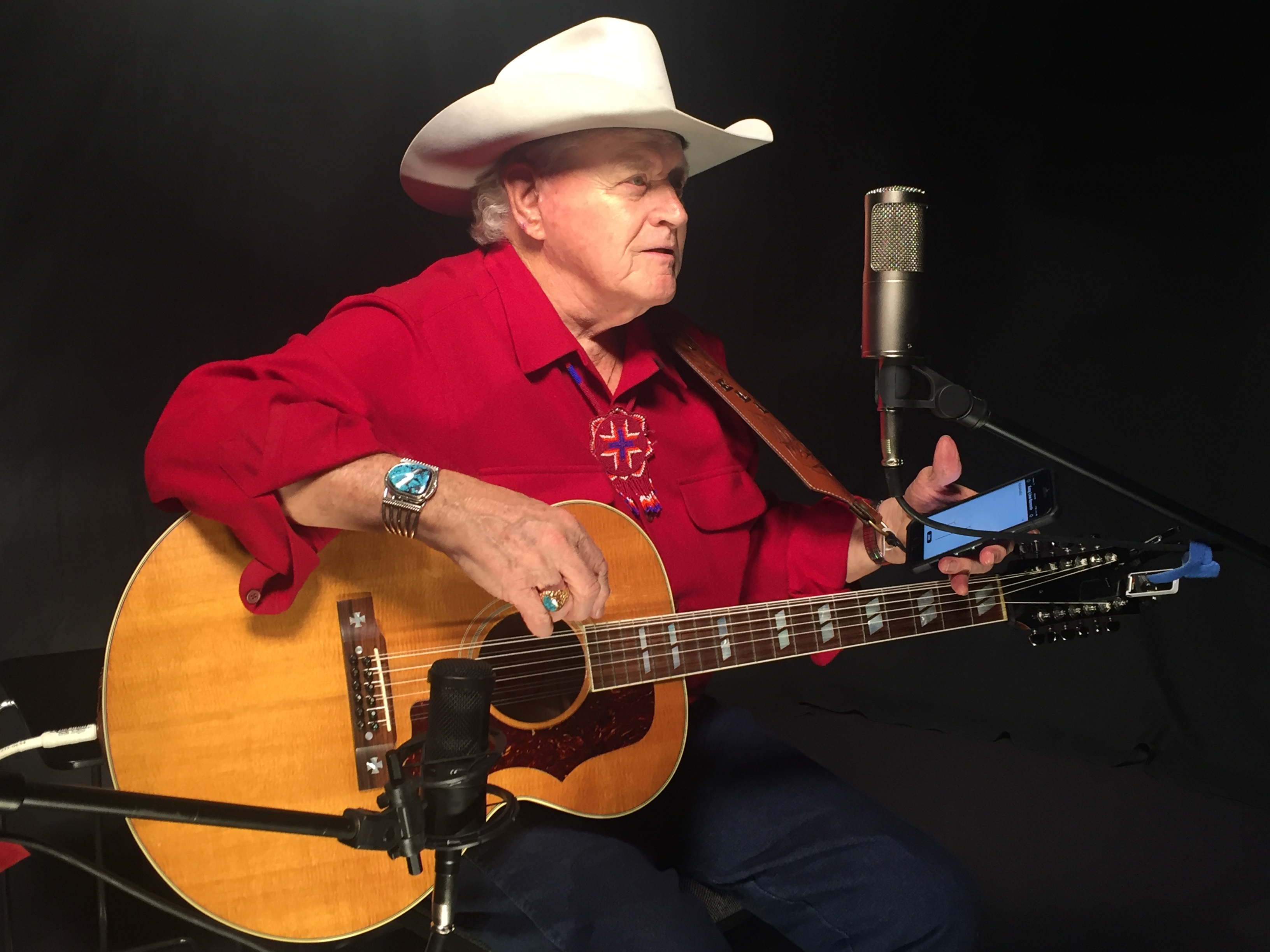 Dolin Ellis with guitar and microphone